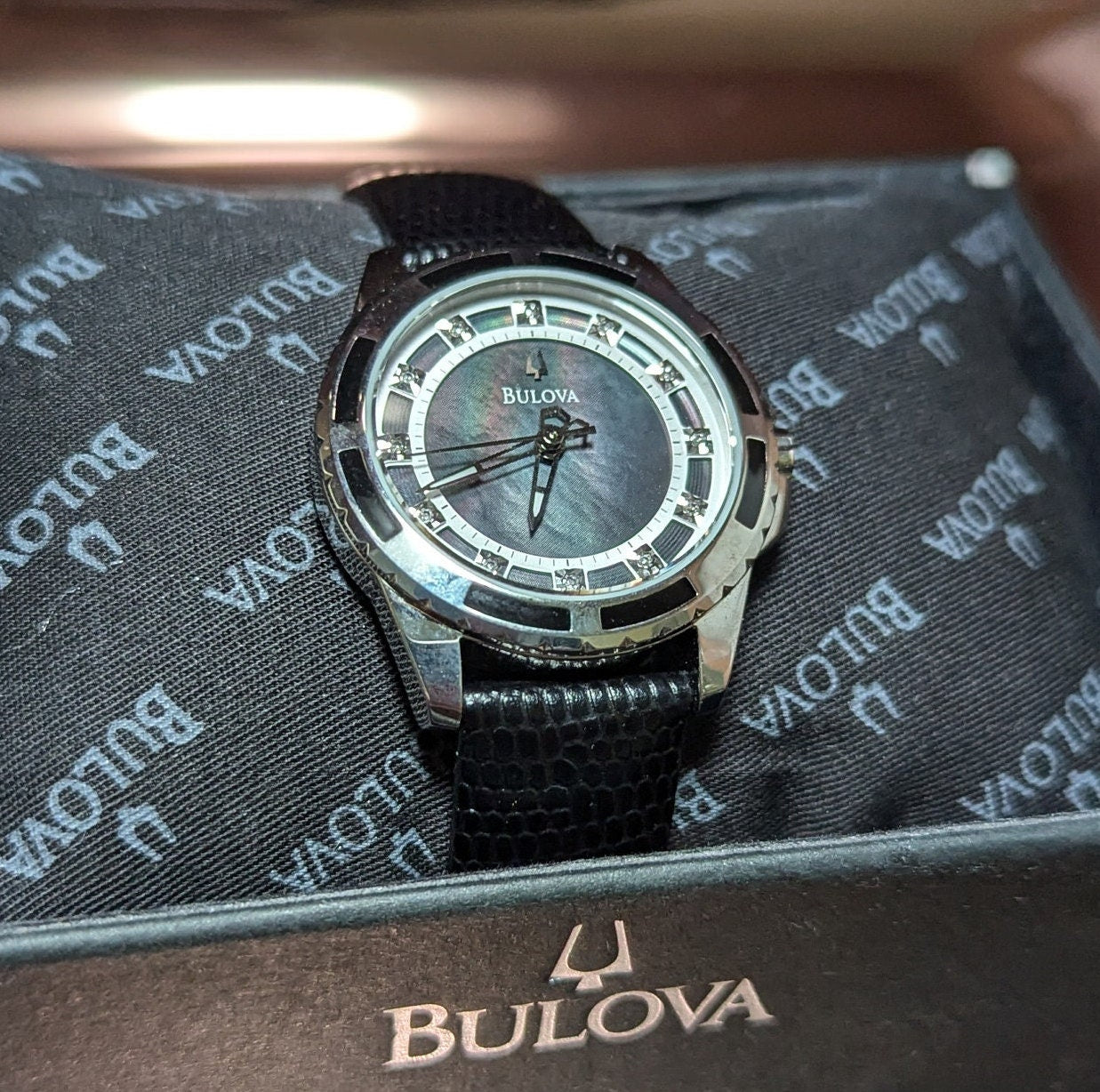 Bulova Ladies Watch: Mother of Pearl Dial, Diamond Hour Marks, Enamel Inlayed Case