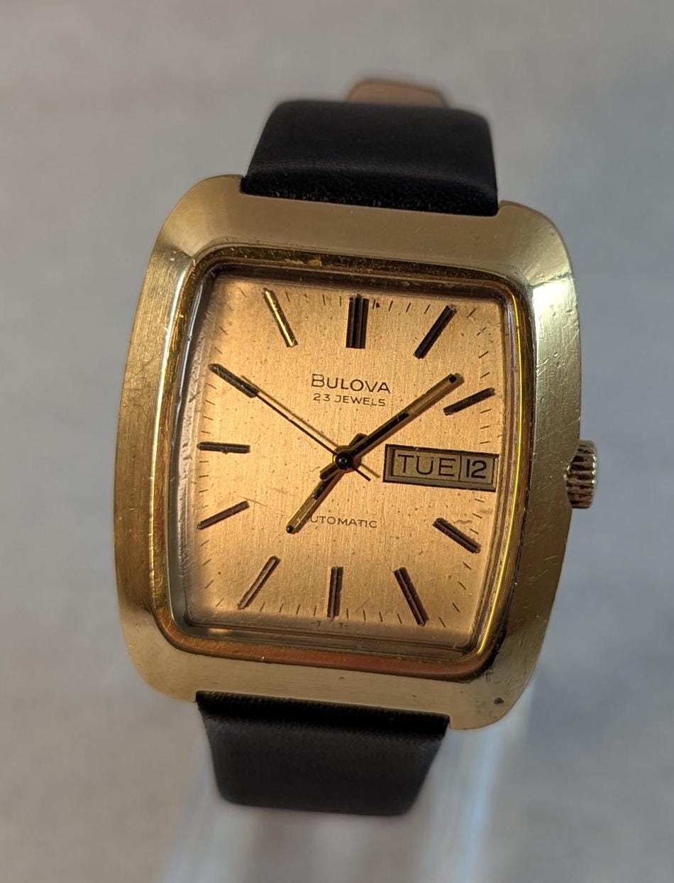 Fantastic & Rare Vintage 1974 Bulova Minute Man Automatic Wristwatch - Gold Tone Case Swiss 23 Jewel Auto Movement with new Leather Band.