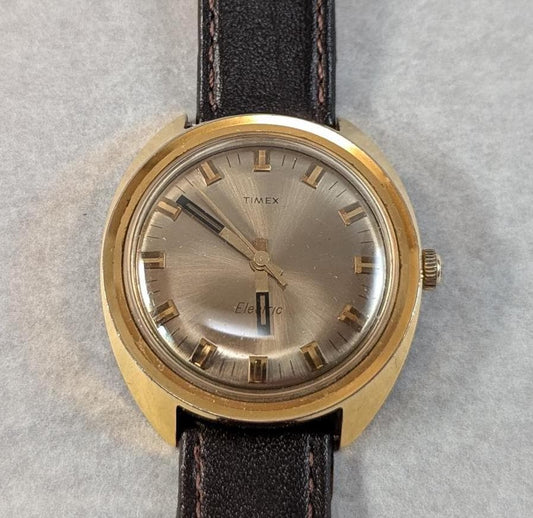 1970s Timex Electric Watch: Gold Tone Bezel, Retro Design