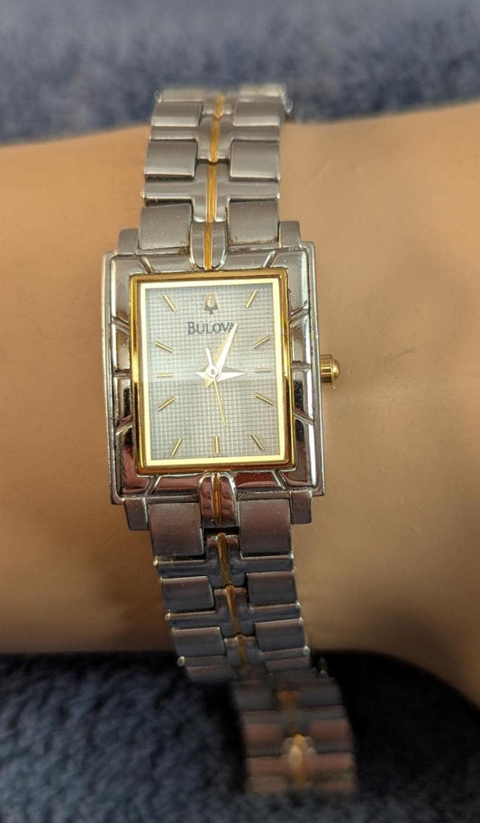 Awesome Bulova Ladies Watch Two Tone Model C9671103 White Dial with Bezel Accents - Small Stainless Steel Band - Working with New Battery