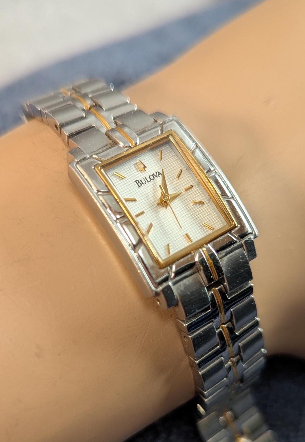 Awesome Bulova Ladies Watch Two Tone Model C9671103 White Dial with Bezel Accents - Small Stainless Steel Band - Working with New Battery
